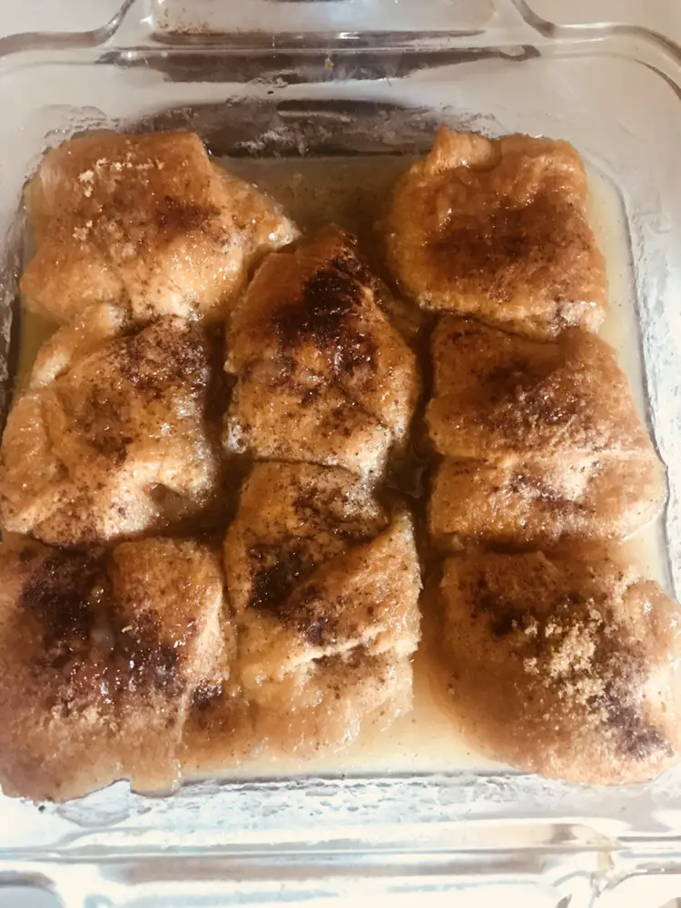 Sweet potato dumplings topped with a sprinkle of sugar and cinnamon and dipped in a sugary syrup.