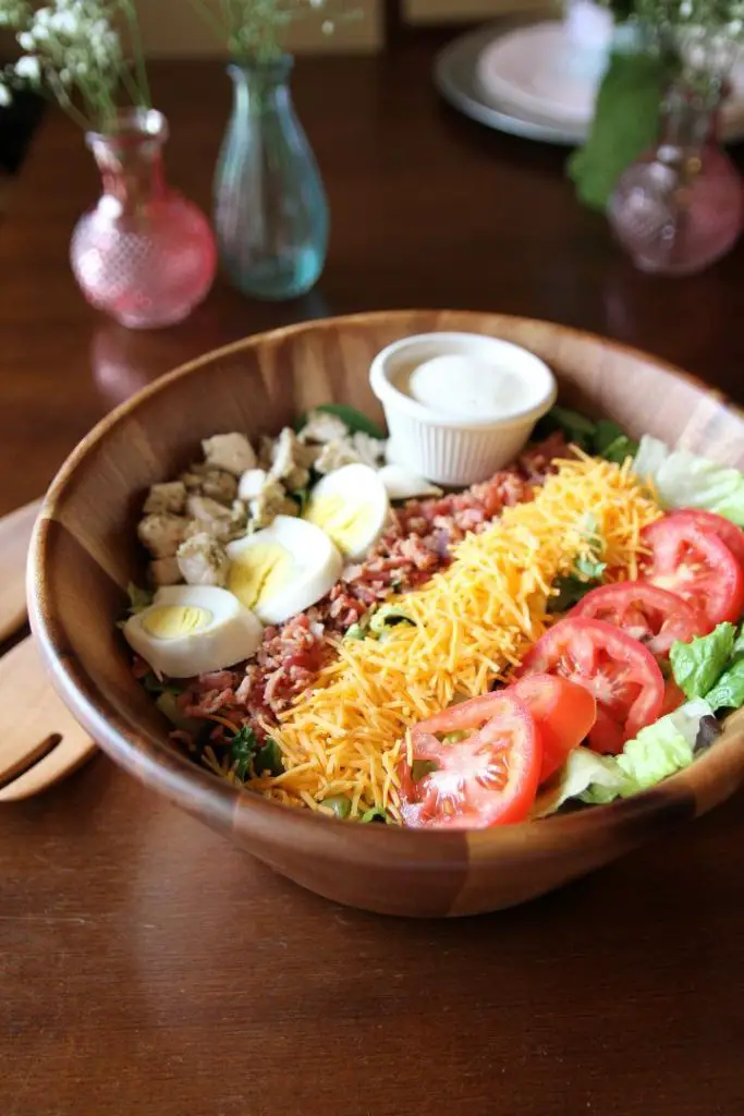 Grilled Chicken Cobb Salad made with vegetables, protein, cheese, and dressing.