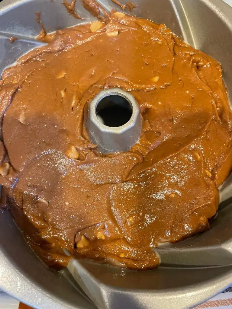 The creamy Chocolate Peanut Butter Bundt Cake is a combination of chocolate cake mix, eggs, chocolate pudding mix, sour cream, vegetable oil, and peanut butter chips.