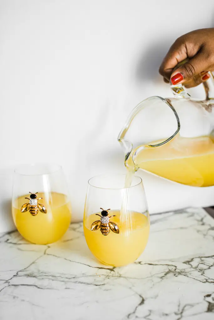 A jug and two glasses of refreshing pineapple lemonade