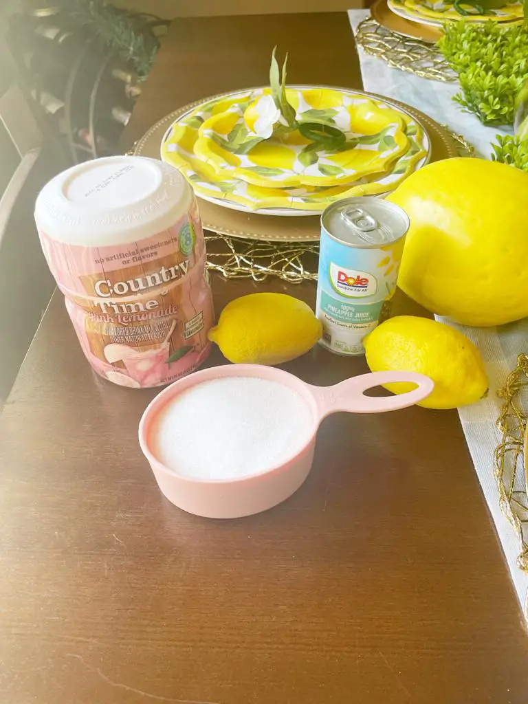 Pink Country Time Lemonade combined with genuine lemon, sugar, pineapple chunks, and juice makes an outstanding lemonade punch.