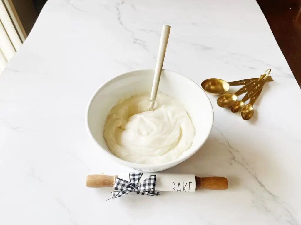 easy and creamy cream cheese icing in a white bowl