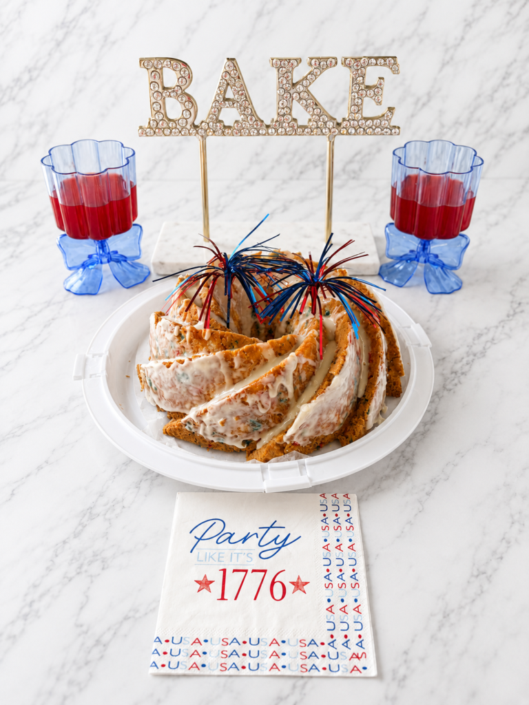 Easy patriotic Funfetti Bundt cake made with boxed cake mix, topped with vanilla glaze and festive Fourth of July decorations.